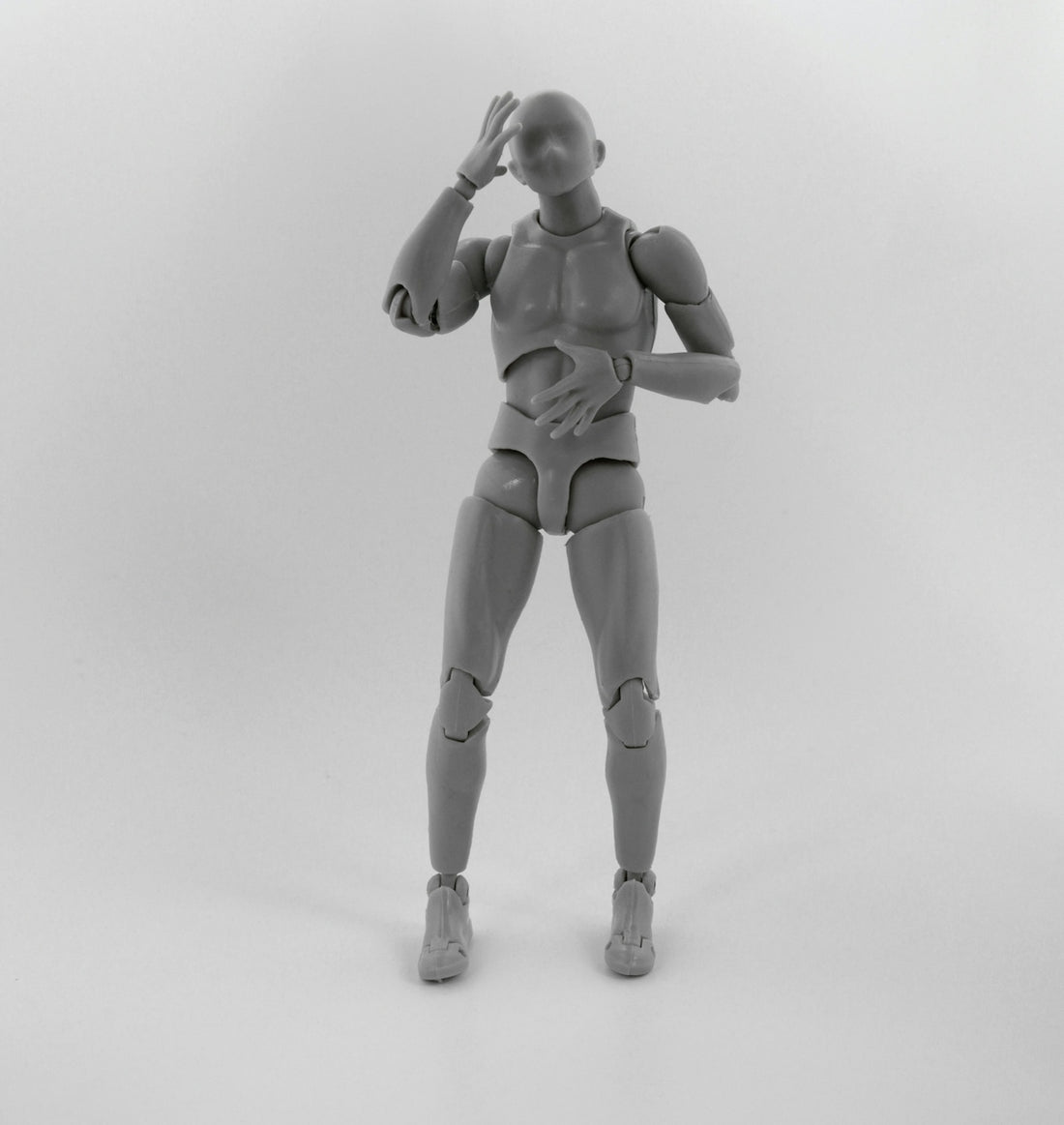 gray robot action figure on white surface
