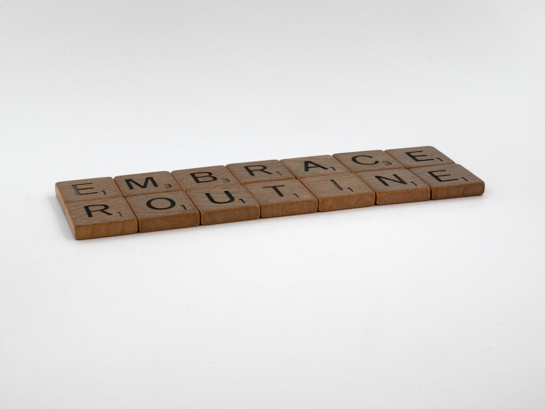 a scrabble tile spelling out the word embrace routine