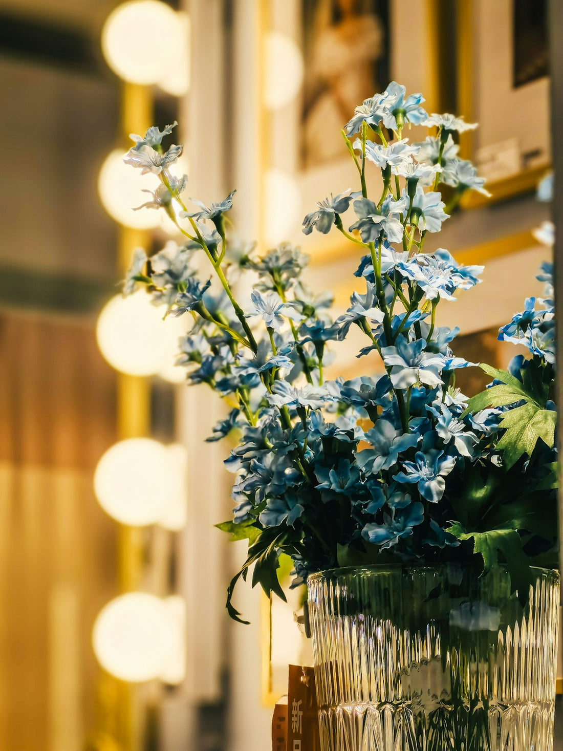 a vase filled with blue flowers sitting on top of a table