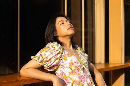 Woman basks in sunlight, enjoying the warm glow.