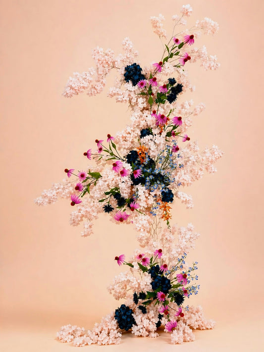 A cascading floral arrangement with pink and blue flowers.